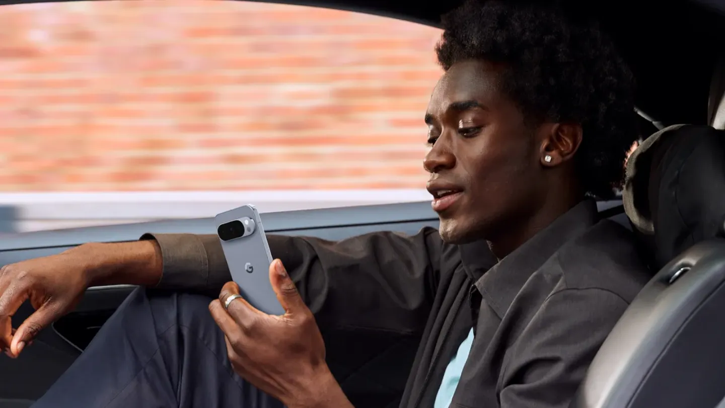 Man in a car using his Android phone.