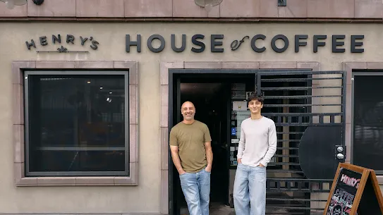 2 men standing outside Henry's House of Coffee