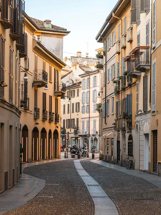 An alleyway with yellow-colored buildings.