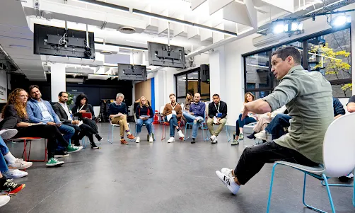 A man is explaining something to team.