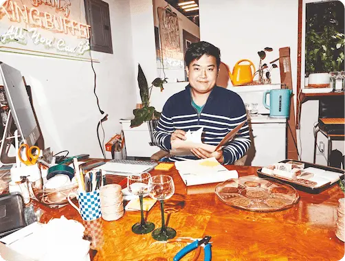 Man sitting at a desk, sorting through various papers