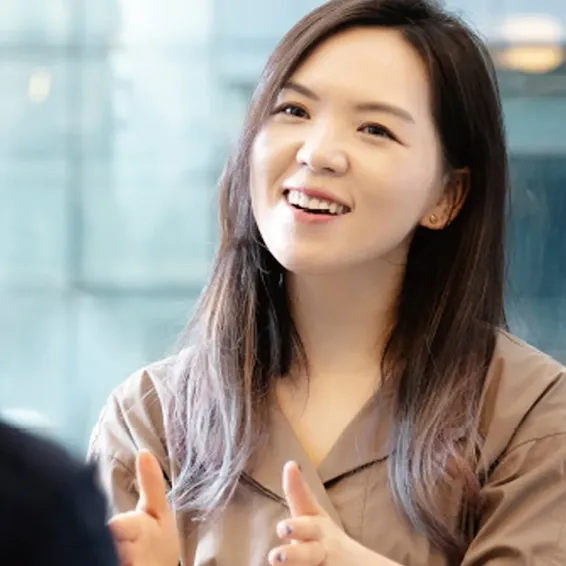 Hanna Kim of Grip smiling while talking to a man