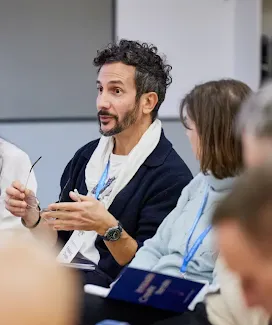 A man explaining to the crowd