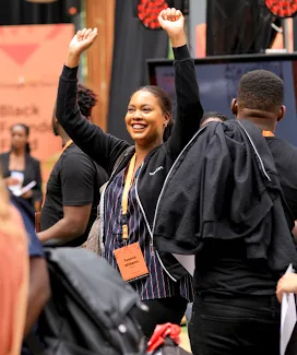 A woman with standing hands laughing.