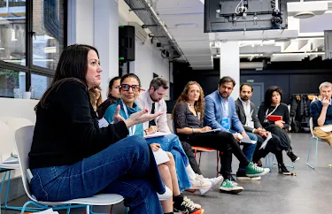 One women is explaining and others are listening to her.