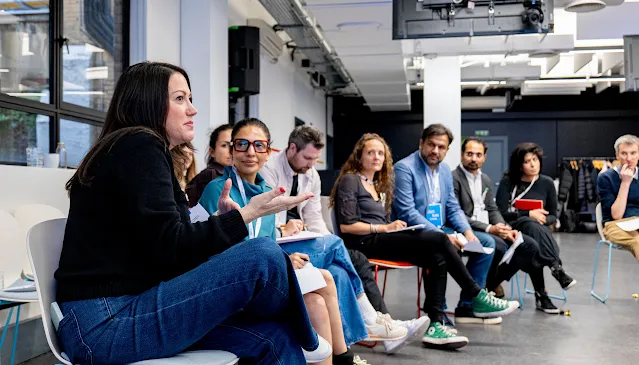 One women is explaining and others are listening to her.