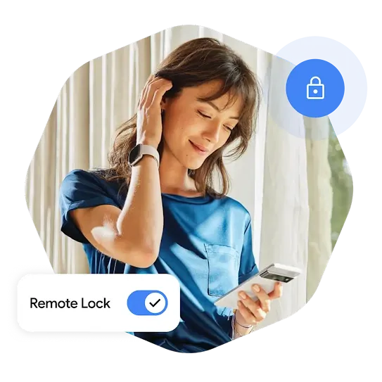 A woman wearing a smartwatch and standing in front of a window with curtains brushes her hair behind her ear and looks down at her phone in hand.