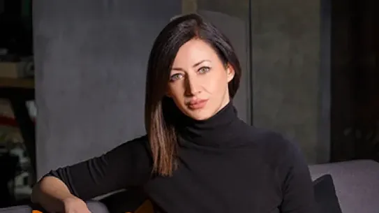 Founder Marija Ilic sits on a sofa facing the camera.