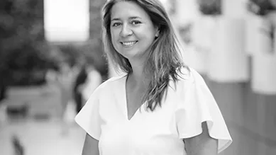 Founder Kasia Dorsey stands along a railing outdoors.