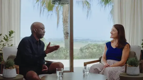 two people conducting an interview in a tropical location
