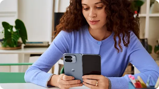 Woman using her Pixel 10 device indoors.