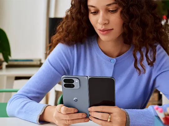 Woman using her Pixel 10 device indoors.
