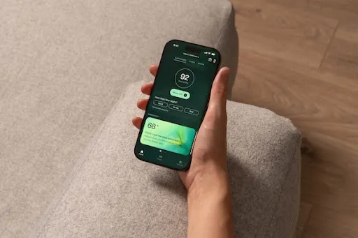 A hand holding a smartphone featuring the Kimba app dashboard.