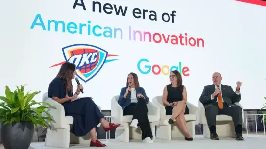 four people on a stage with the Google and OKC logos