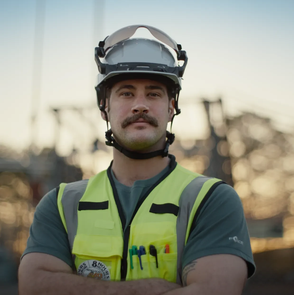 A man poses in a hard hat