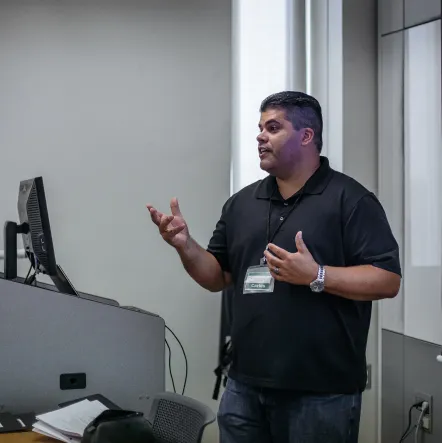 A teacher stands in front of the class.