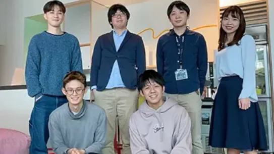 The Latona team pose together indoors for the camera.