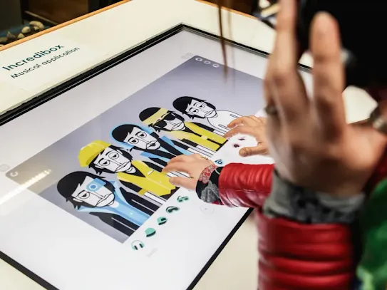 People playing with Incredibox on a large screen.
