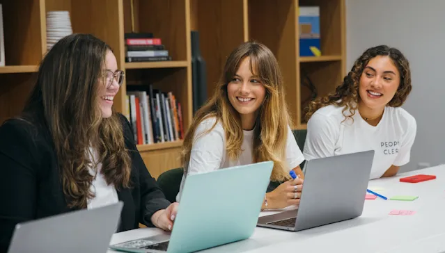 Three women discussing something.