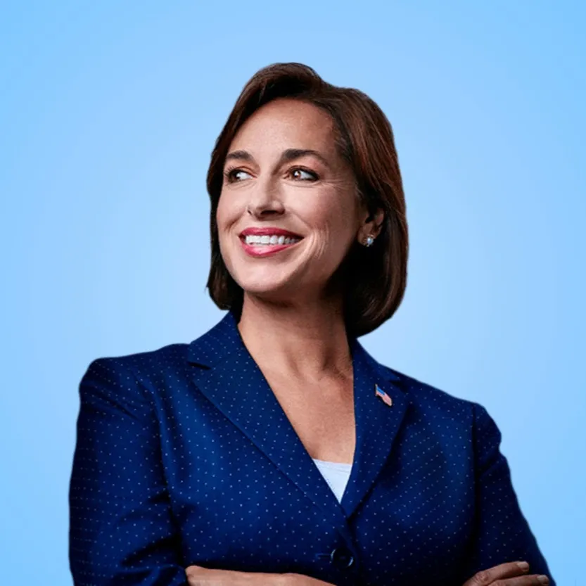A photograph of the author, Dr. Karen DeSalvo, standing with arms crossed against a light blue background