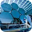 Two technicians in white clean suits working on a large, futuristic array of hexagonal mirrors in a high-tech facility.
