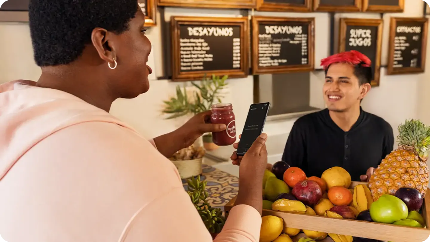 Using contactless payments on their smartphone, a customer uses Tap and Pay to purchase their drink.