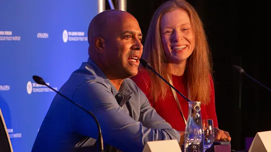 Googler David Graff speaking at the TPI Aspen Forum with moderator Sarah Oh Lam smiling beside him.