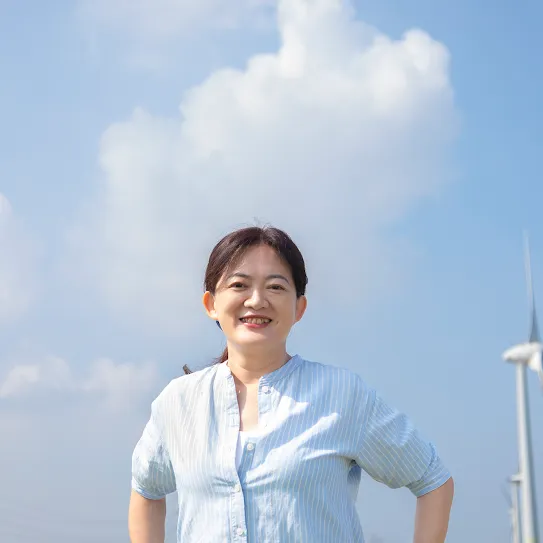 Googler Melody Chang stands in front of windmill in Changhua County Taiwan