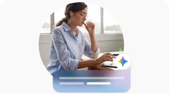 A person in business casual attire has earbuds on looking at a laptop at a wooden table. The Google Gemini icon and prompt interface is at the lower right corner.
