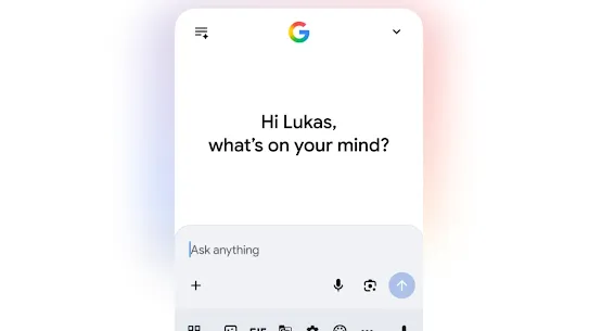 A clean, modern mobile UI screenshot from a Google AI app. The screen displays a personalized greeting, "Hi Lukas, what’s on your mind?", with a prompt "Ask anything" in the text bar. The interface features the Google logo and a toolbar with icons for voice, camera (Lens), and various shortcuts, representing the latest AI feature announcements.
