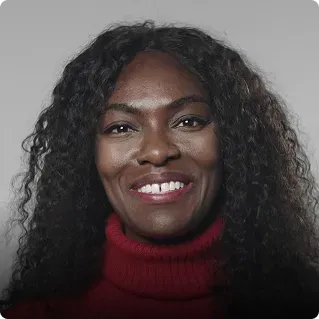 A woman wearing red top is looking at camera and a light meter is kept near her face.