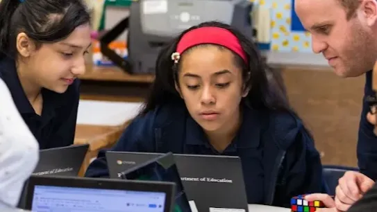 Image of children at laptops in a classroom