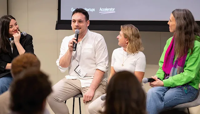 A group of people is engaged in a deep discussion, with microphones in their hands.