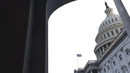 White House view through an arch with American flag