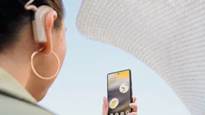 Person with a cochlear implant holds Android phone in front of them.