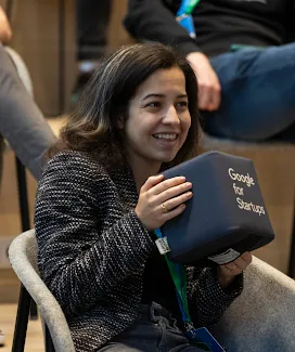 A woman holding GFS gift box