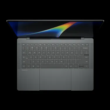 Googlebook laptop open, viewed from above, showing the keyboard and rainbow-gradient display.