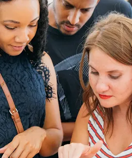 Three persons looking at mobile