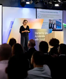 A presenter addressing the crowd at a conference.