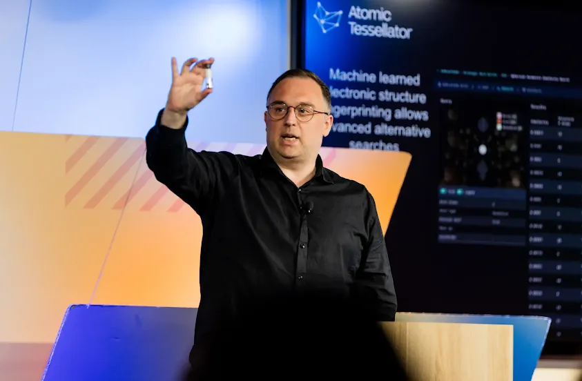A person hosting an event and standing at a podium.