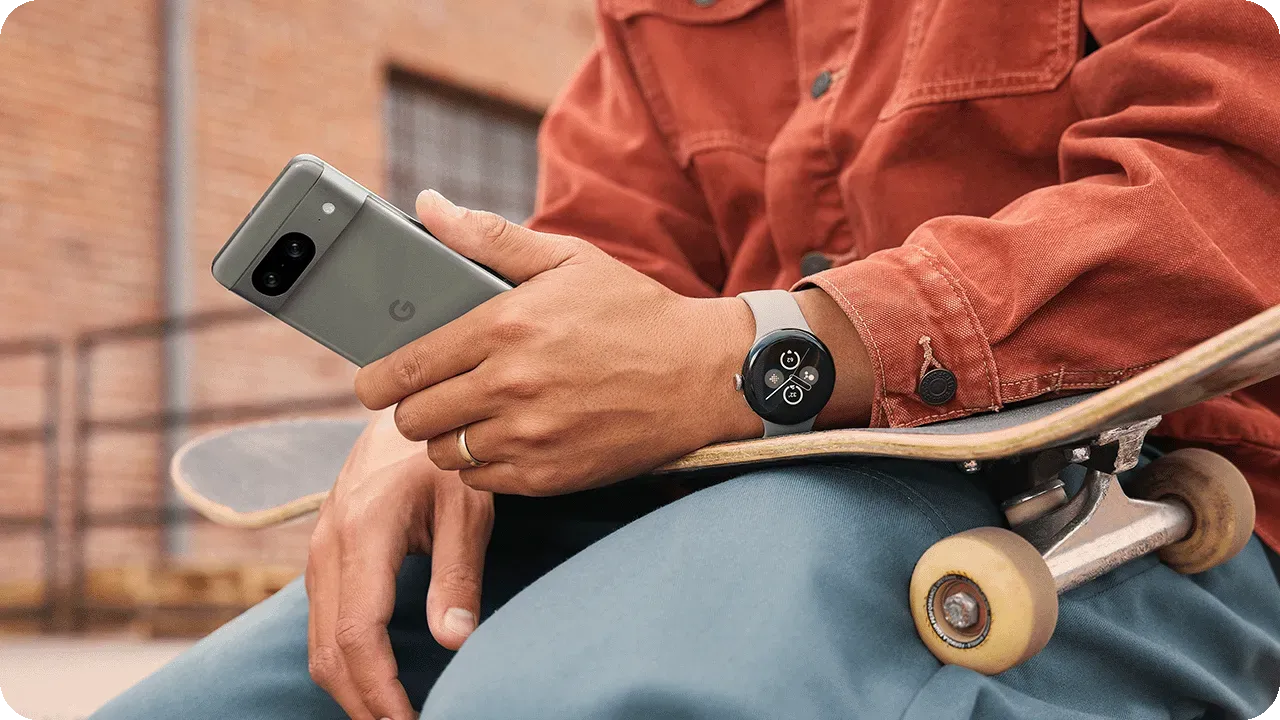 Close up of a man using a smartwatch in tandem with his Android phone.