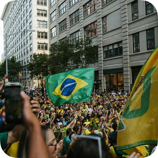 Crowd waving a Brazilian flag at a major public event managed by Waze for Cities event traffic routes