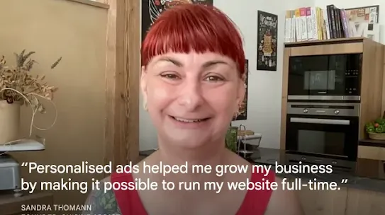 A portrait of Sandra Thomann, Founder of Cuisine Addict, smiling in a kitchen setting with cookbooks and an oven in the background. Overlaid white text reads: “Personalised ads helped me grow my business by making it possible to run my website full-time.” Her name and title are displayed at the bottom-left corner.