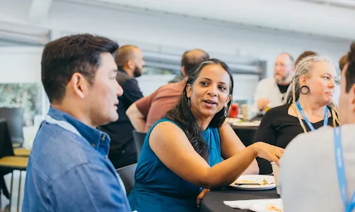 A group of men and women discussing something