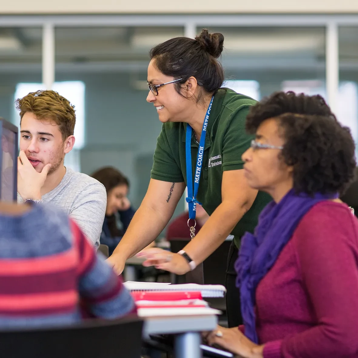 Three people in a classroom setting