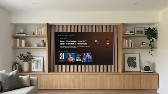 Image of a Google TV device displaying an NBA brief in a bright living room.