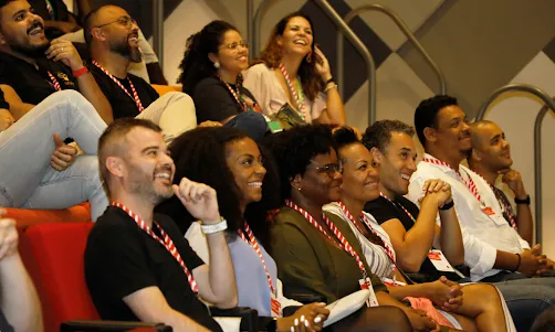 A team sited in the conference room, smiling.
