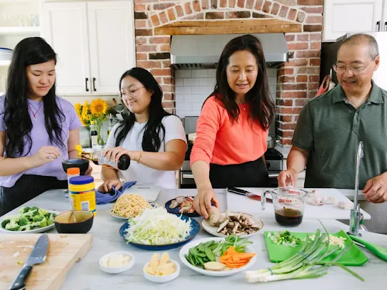 The Leung family cooking in the kitchen. Photo credit: Christine Han