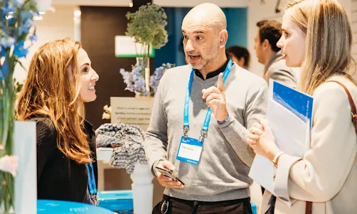 one men and two women talking each other