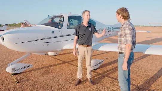 Aerial waves meeting a sandy beach with circular timer graphic and text reading “AI & saving Aussies’ eyesight in 5 mins”.